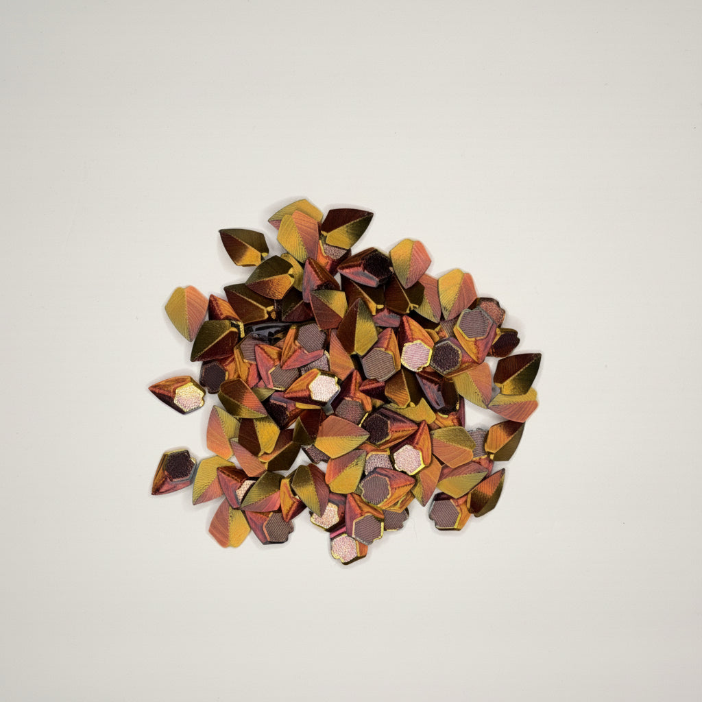 Red, black, gold loose dragon scales on a light gray background
