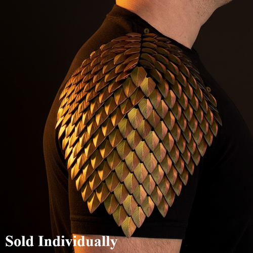 Person wearing a dragon scale shoulder piece on a black background