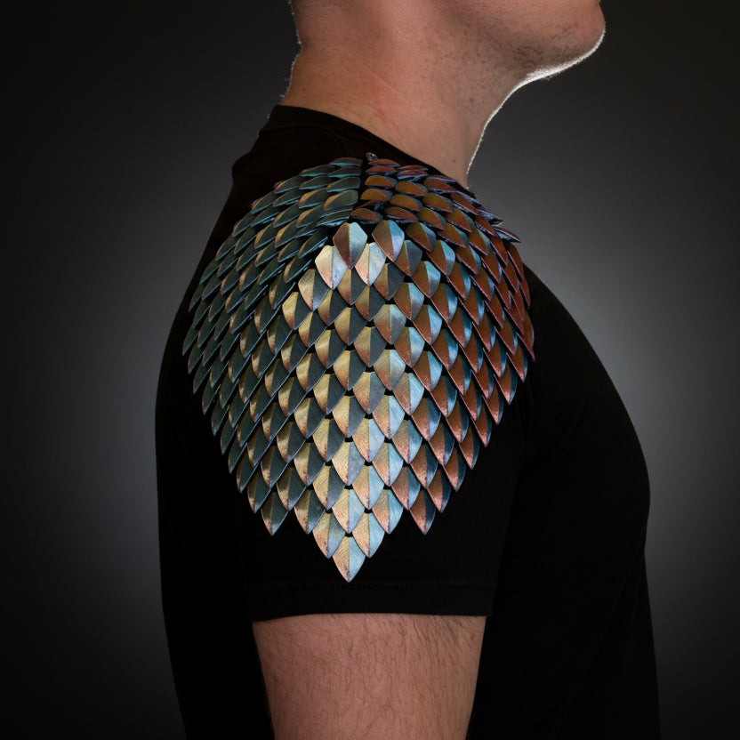 Person wearing a black t-shirt with a dragon scale shoulder pad design.