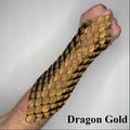 Arm with dragon scale bracer labeled 'Dragon Gold' on a plain background