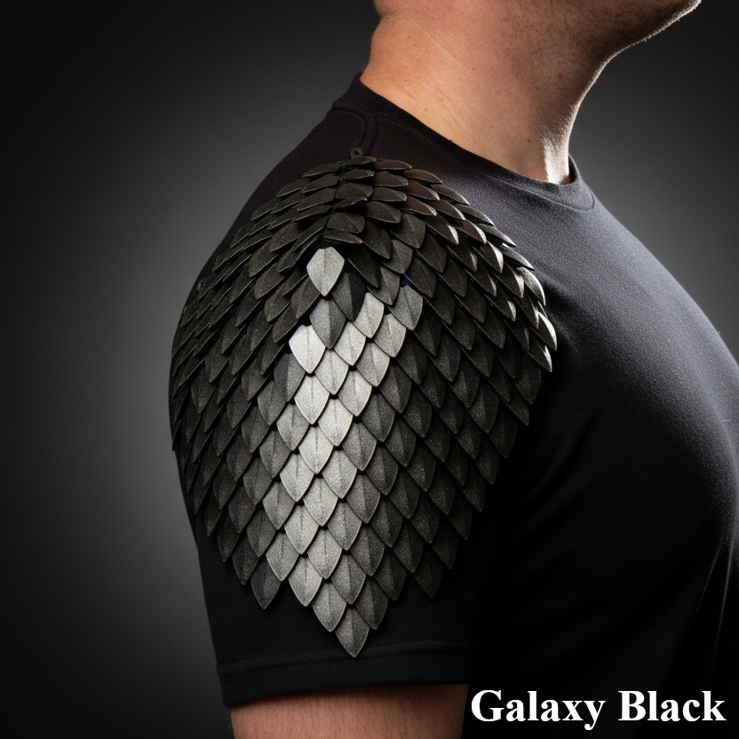 Person wearing a black t-shirt with dragon scale shoulder design on a dark background