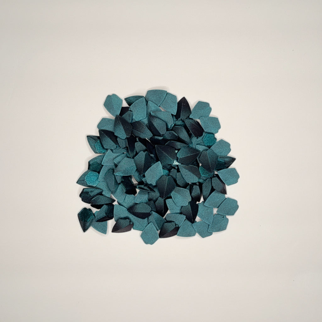 Circular arrangement of dark green loose dragon scales on a light gray background