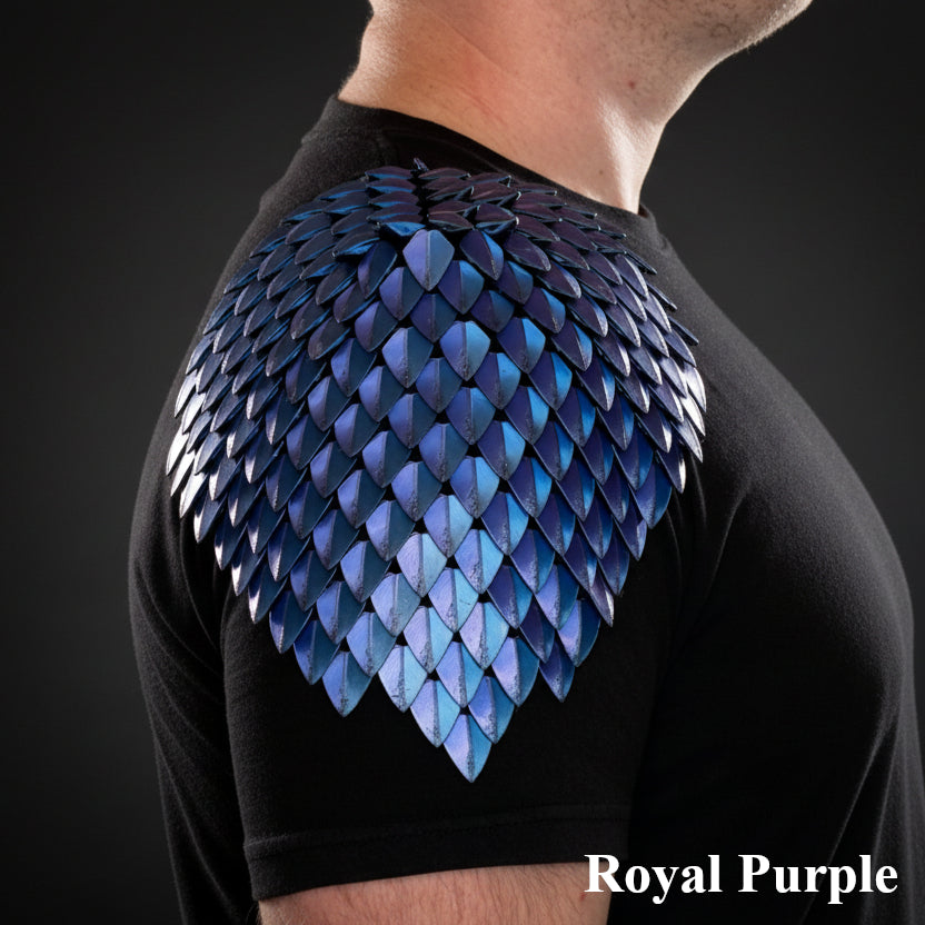 Person wearing a black shirt with blue dragon scale shoulder armor on a dark background