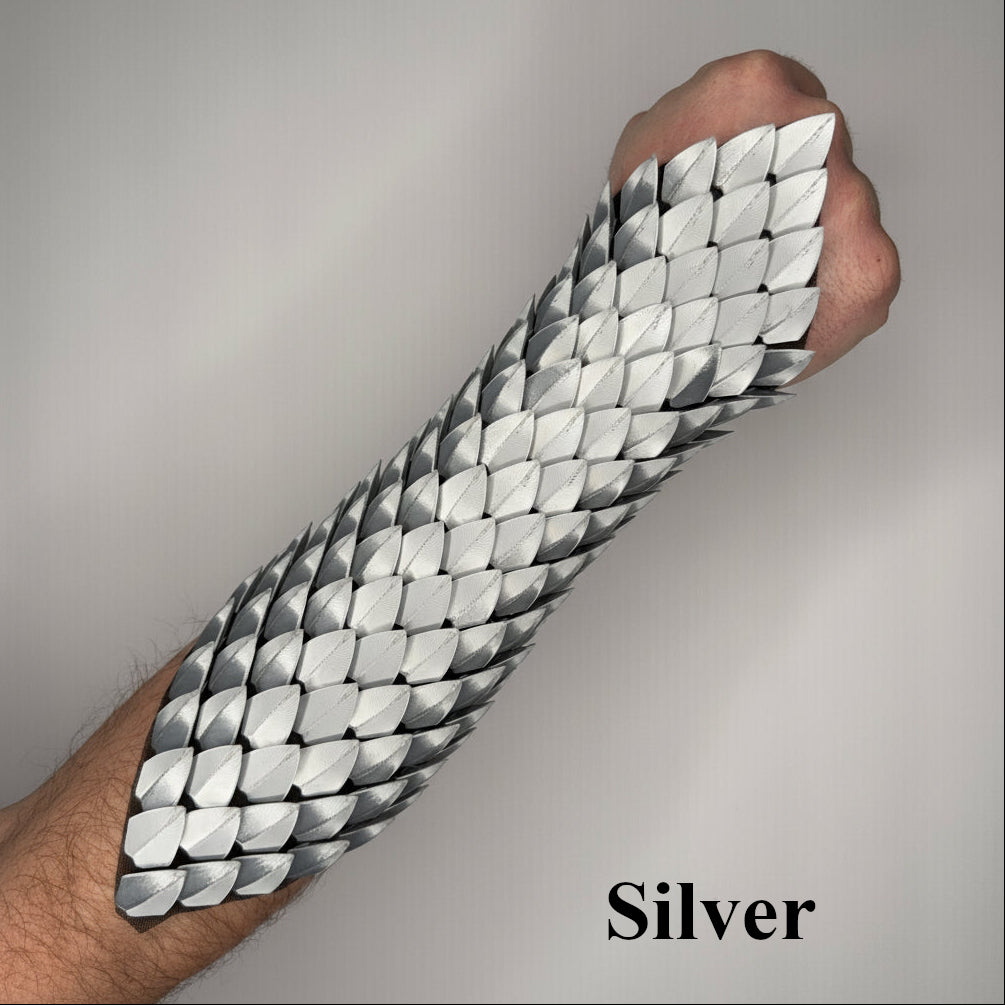 Silver arm sleeve with geometric pattern worn by a person on a plain background