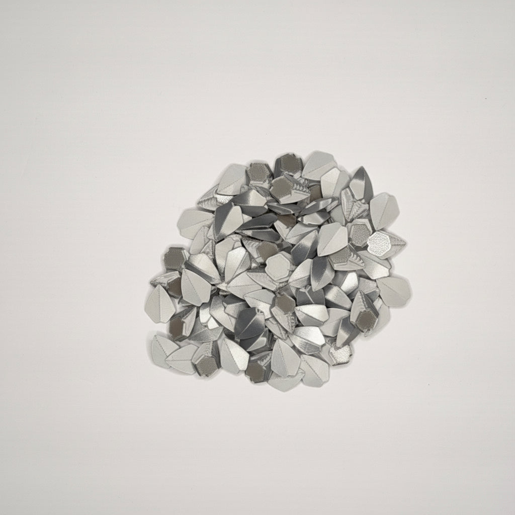 Silver loose dragon scales on a light gray background