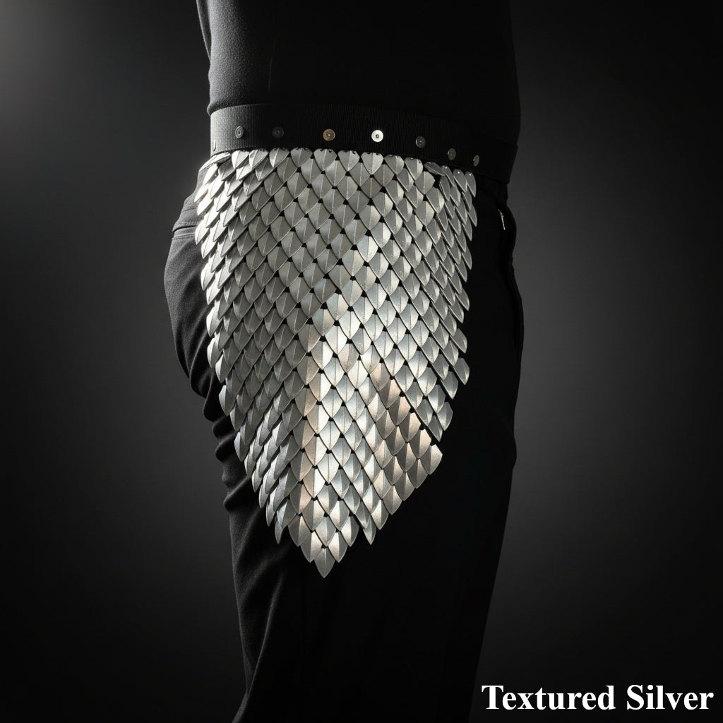 Textured silver armor piece on a dark background